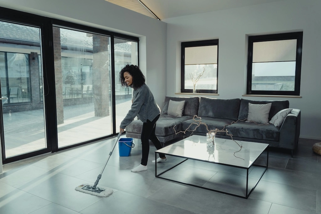Cleaner mopping floor in dirty Airbnb property