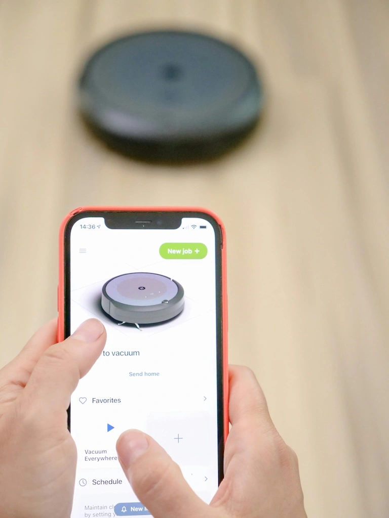 Robot vacuum cleaning hardwood floor in a modern flat
